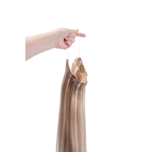 Hand Holding Biscuit Blondey (#18/613) Halo Hair Extensions