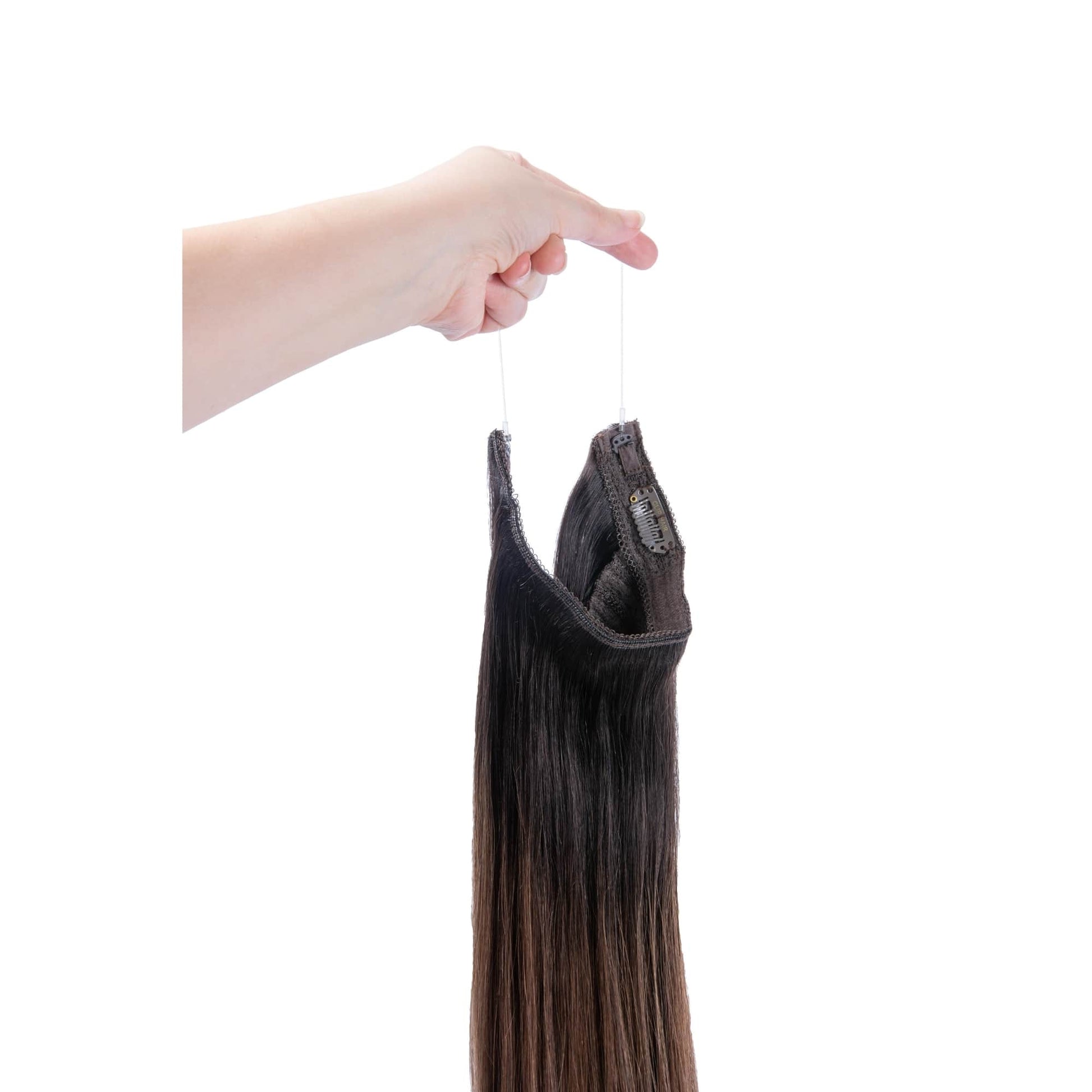 Hand Holding Espresso Melt Balayage Halo Hair Extensions