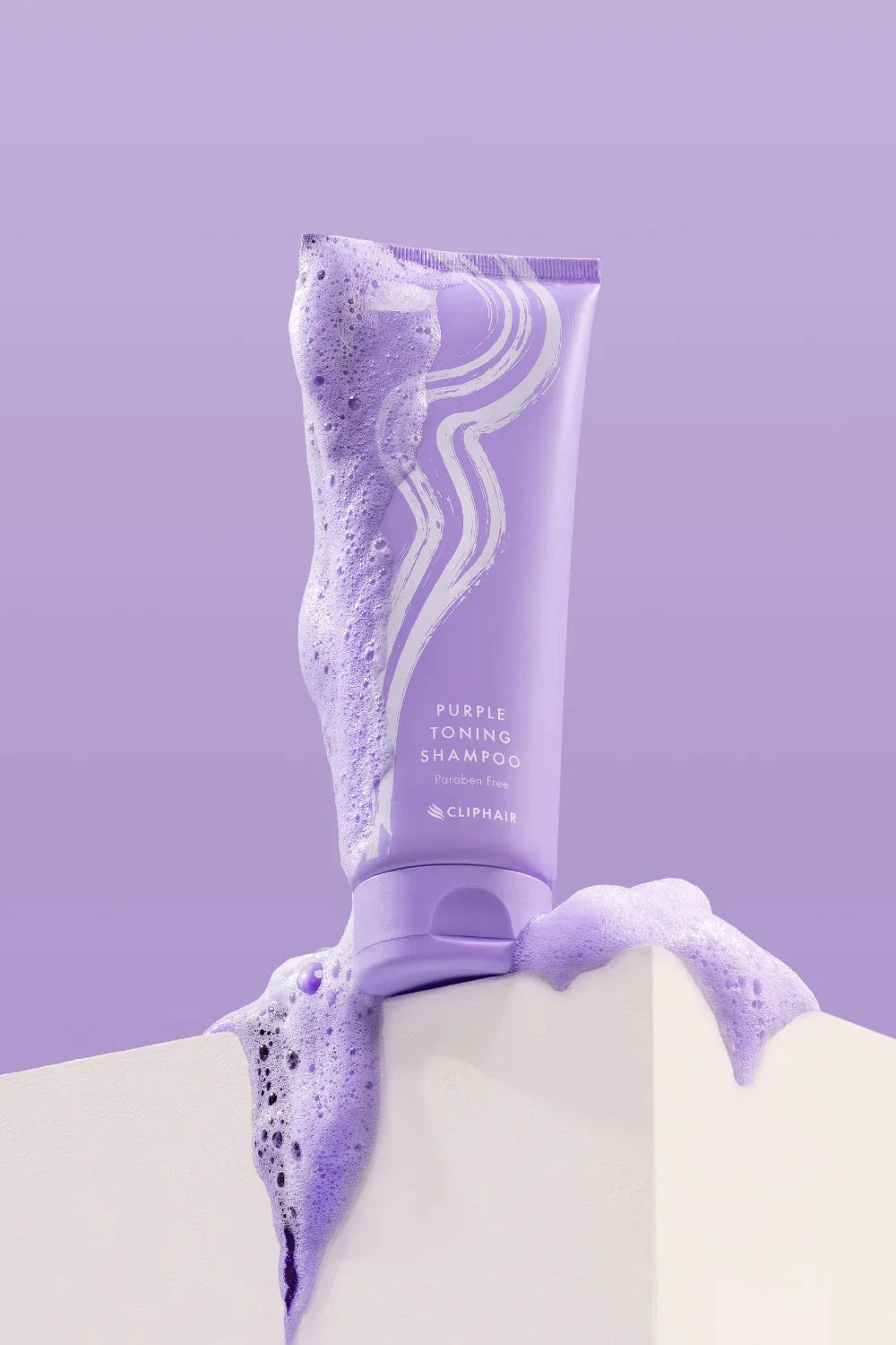 purple shampoo product bottle and foam